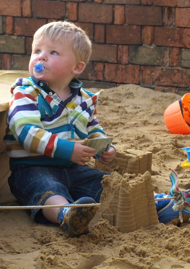 child playing in sand